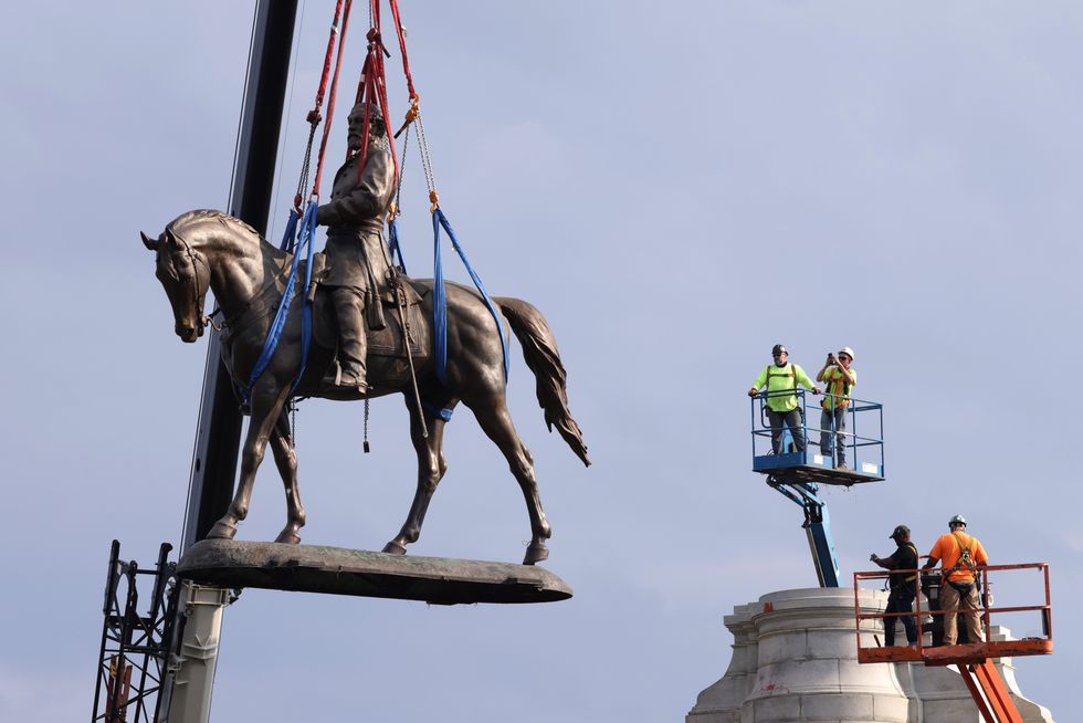 richmond, virginia   september 08 the statue of robert e lee is lowered from its pedestal at robert e lee memorial during a removal september 8, 2021 in richmond, virginia the commonwealth of virginia is removing the largest confederate statue remaining in the us following authorization by all three branches of state government, including a unanimous decision by the supreme court of virginia photo by alex wonggetty images