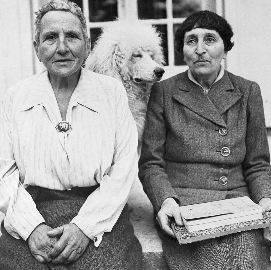 original caption gertrude stein, one of the worlds foremost novelists, poses with alice b toklas, and her dog, basket, in front of her home in france the grand lady of fiction lived in a chateau near paris during the four years of nazi occupation, but her identity was kept secret she has written a new book, part of which miss toklas is holding, which will be released for publication shortly