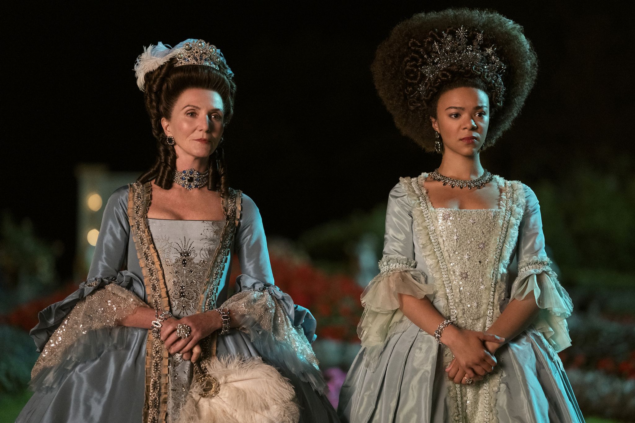michelle fairley as princess augusta and india amarteifio as queen charlotte in ﻿queen charlotte a bridgerton story